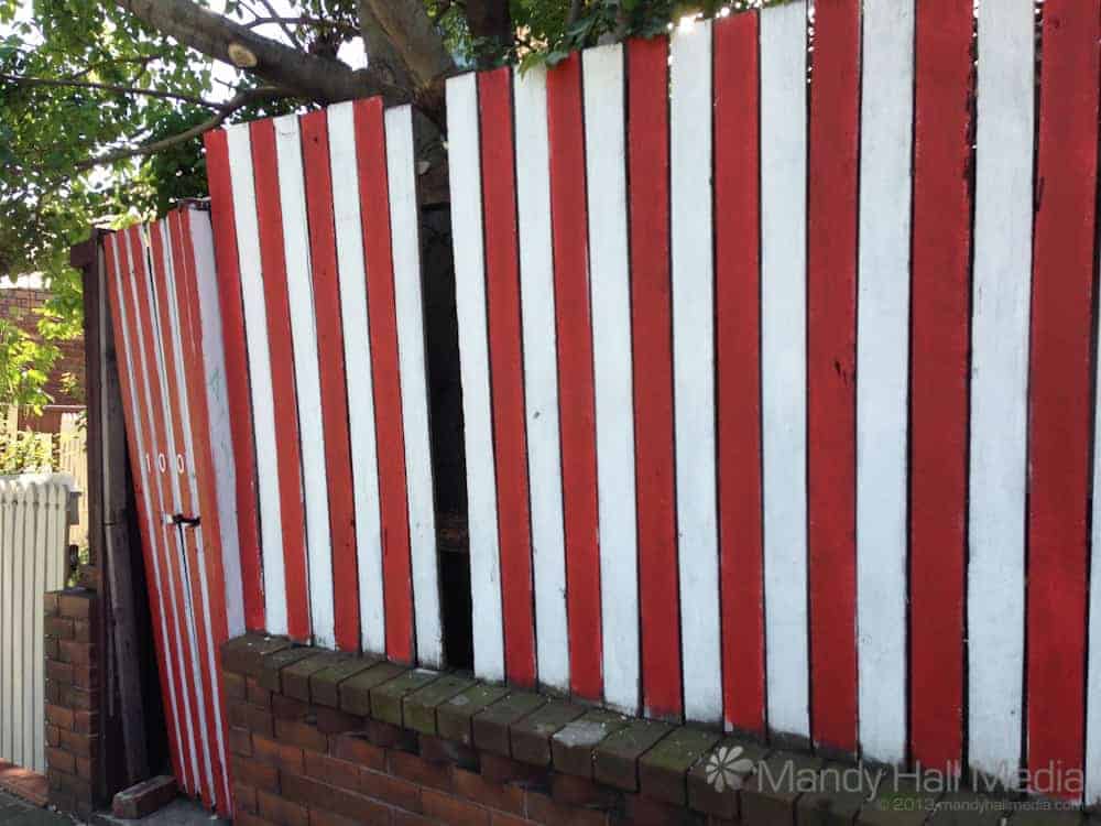Red and white fence in a very green suburb in Sydney
