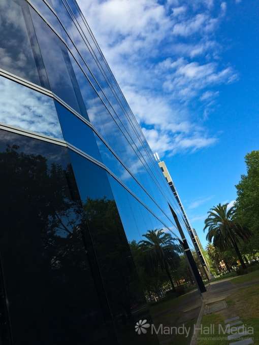 A blue afternoon reflected in the building