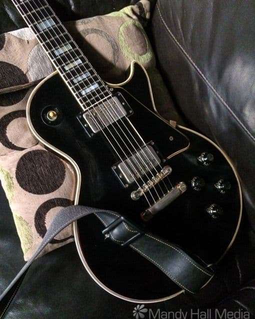 Vintage guitar having a rest on the couch