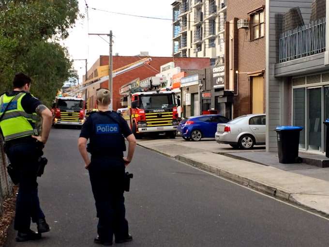 Police casually protecting the public from a fire