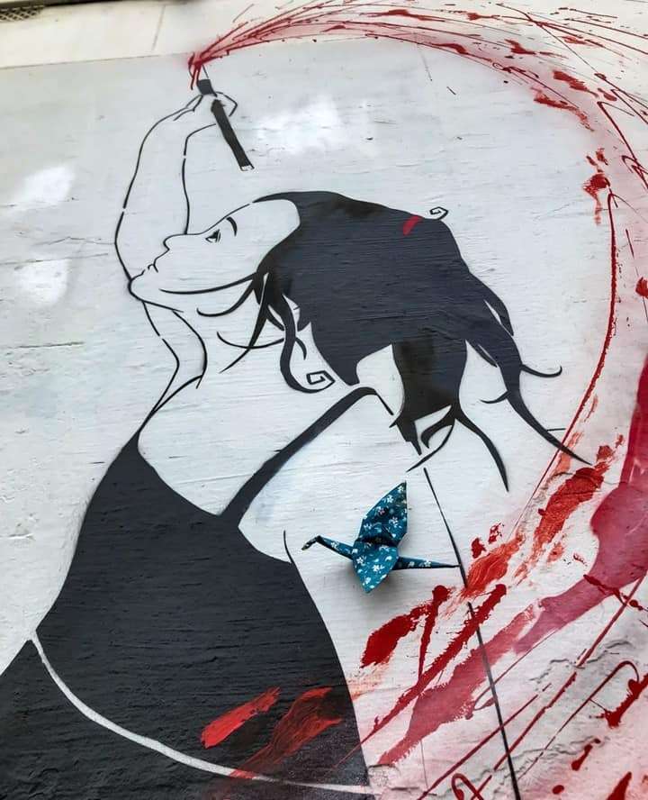 Girl on the wall with origami cranes